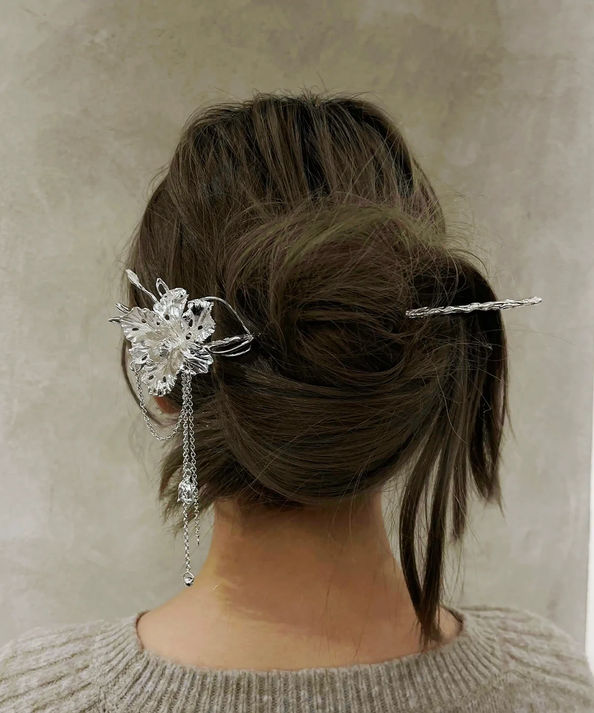 950 silver iris flower hair stick worn through a low twisted bun