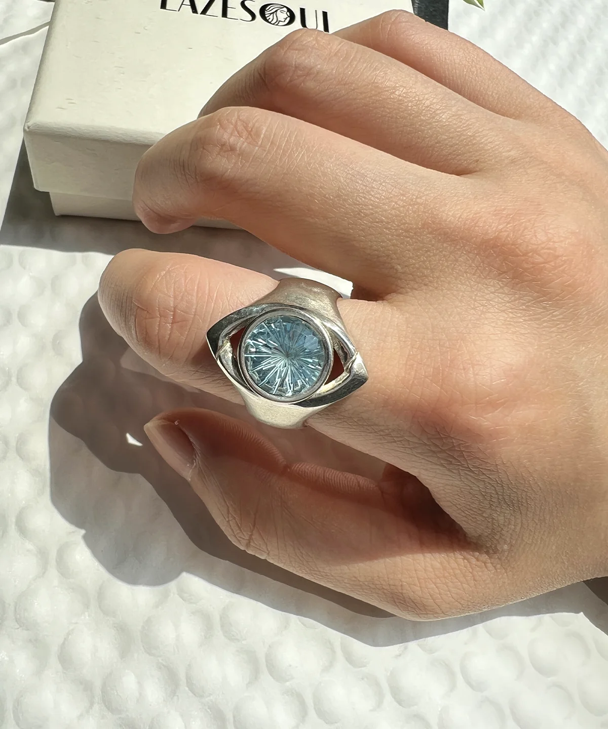 Side view of Six Eyes Ring showing the blue topaz stone and layered S925 sterling silver details
