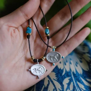Handmade sterling silver horse pendant necklace with turquoise beads and leather cord
