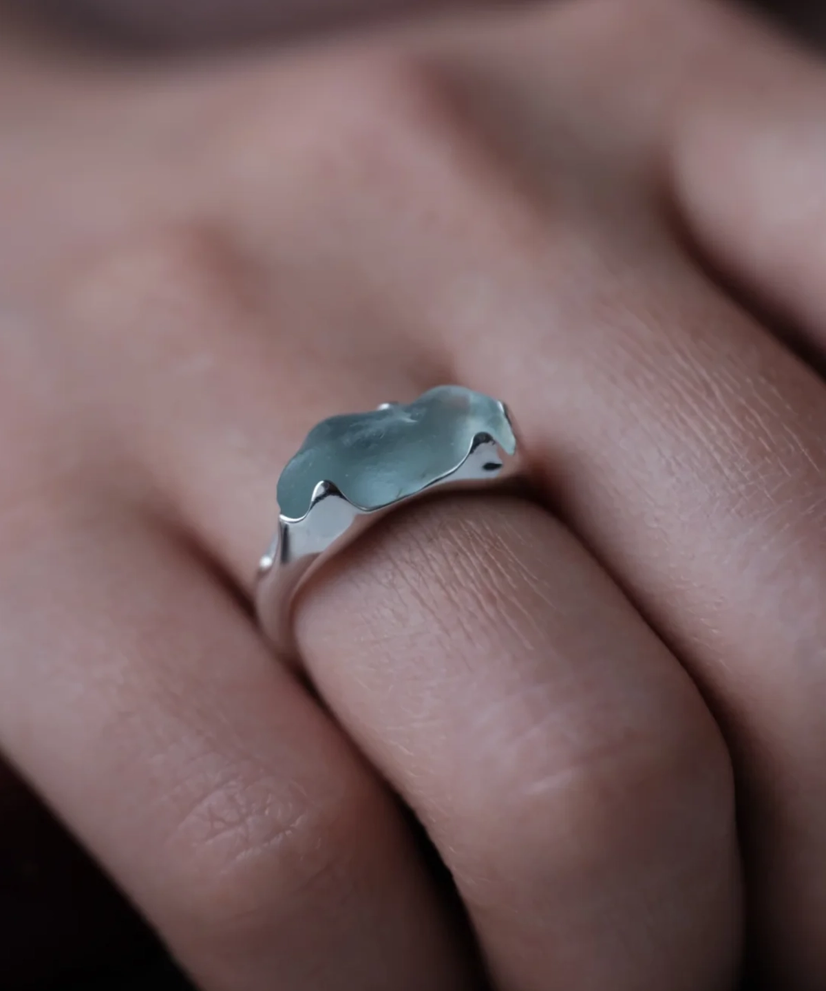 Irregular natural aquamarine custom ring in S925 sterling silver worn on a finger