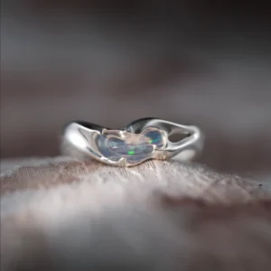 Handmade natural opal silver ring showing green and blue play of color