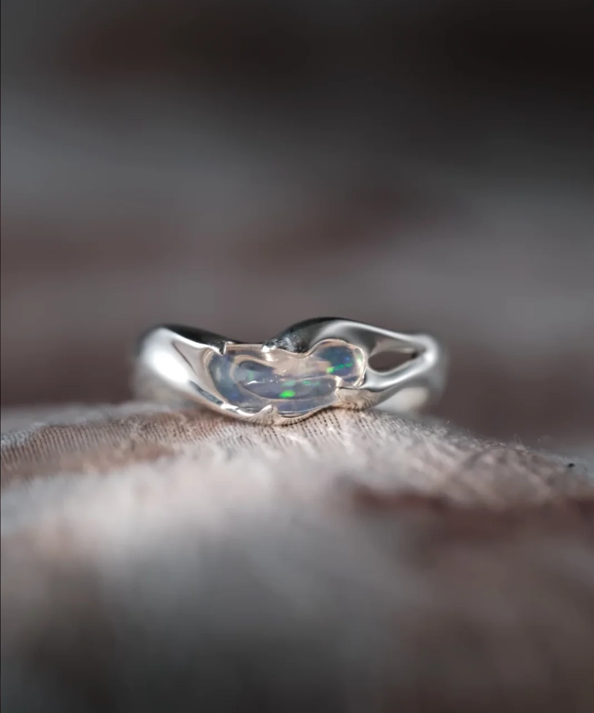 Handmade natural opal silver ring showing green and blue play of color