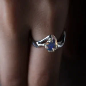 Natural opal custom silver ring worn with blue violet and green color flashes
