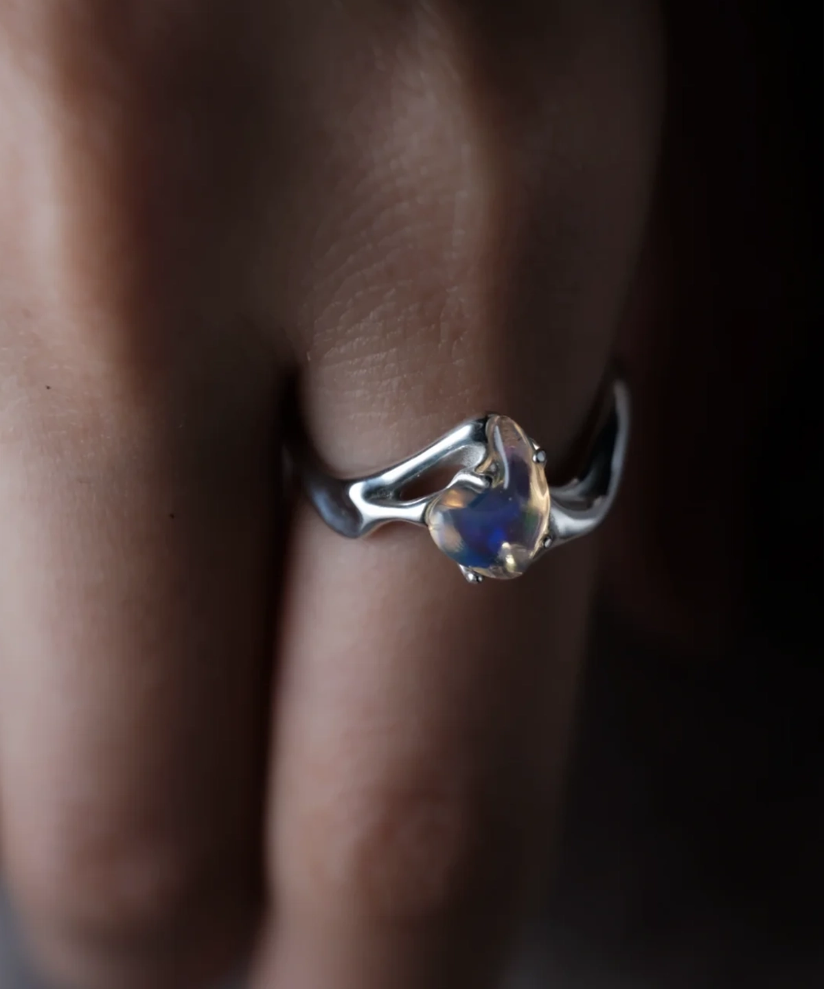 Natural opal custom silver ring worn with blue violet and green color flashes