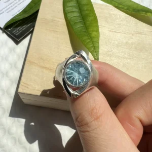 Six Eyes Ring in sterling silver with a blue topaz centerpiece and detailed handmade silver texture