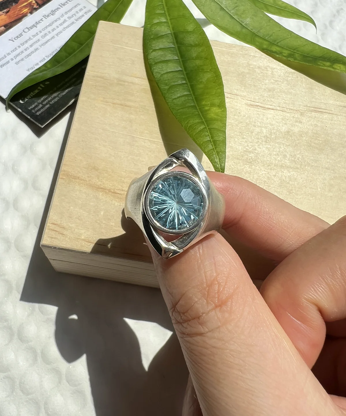 Six Eyes Ring in sterling silver with a blue topaz centerpiece and detailed handmade silver texture
