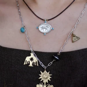 Turquoise horse pendant necklace in sterling silver worn as a layered boho necklace