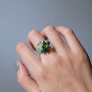 Angled close-up of Unripe Green gemstone cluster ring worn on hand