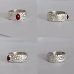 Multiple views of the I Set a Fire red agate silver ring arranged on white blocks