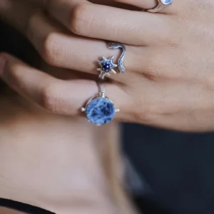 Close-up of lapis lazuli ring with irregular silver star and carved trail