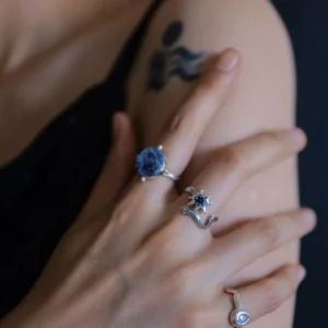 Lapis lazuli star ring styled with blue gemstone rings on one hand