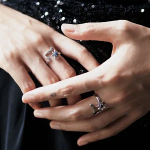 Night Wish star ring worn on crossed hands with other silver rings