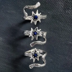 Sterling silver lapis lazuli ring shown from three directions on a dark surface