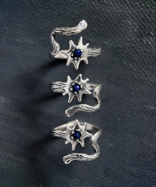 Sterling silver lapis lazuli ring shown from three directions on a dark surface