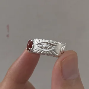 Side detail of the eye motif and natural Nanhong agate on a 999 fine silver ring