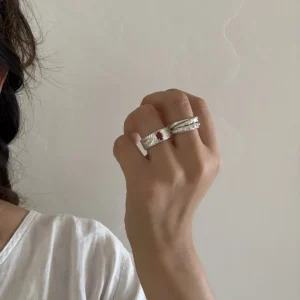 Wide silver eye ring with natural red agate worn alone on the hand