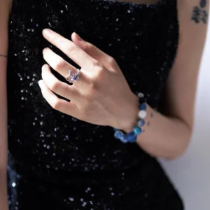 Silver lapis lazuli ring worn with a black dress and blue stone bracelet