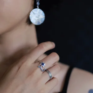 Silver lapis lazuli ring worn in a portrait with a pale circular pendant
