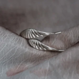 Cutout feather details on a matte sterling silver wing ring