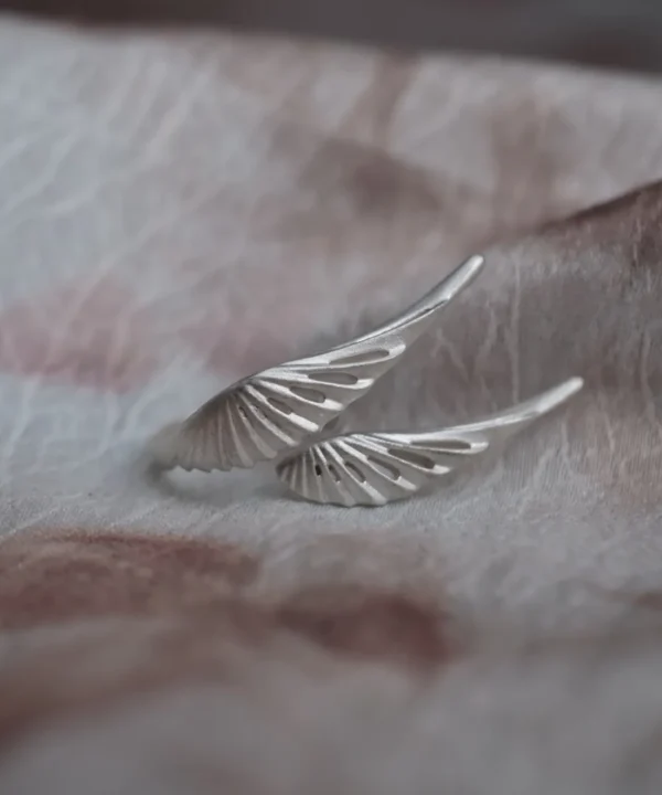 Sterling silver wing ring with two open feather forms in a matte finish