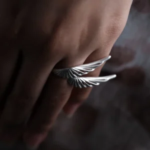 Matte S925 silver wing ring worn on the hand from the side