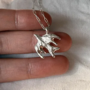 Abstract bird pendant in 999 fine silver with open wing details on a silver chain