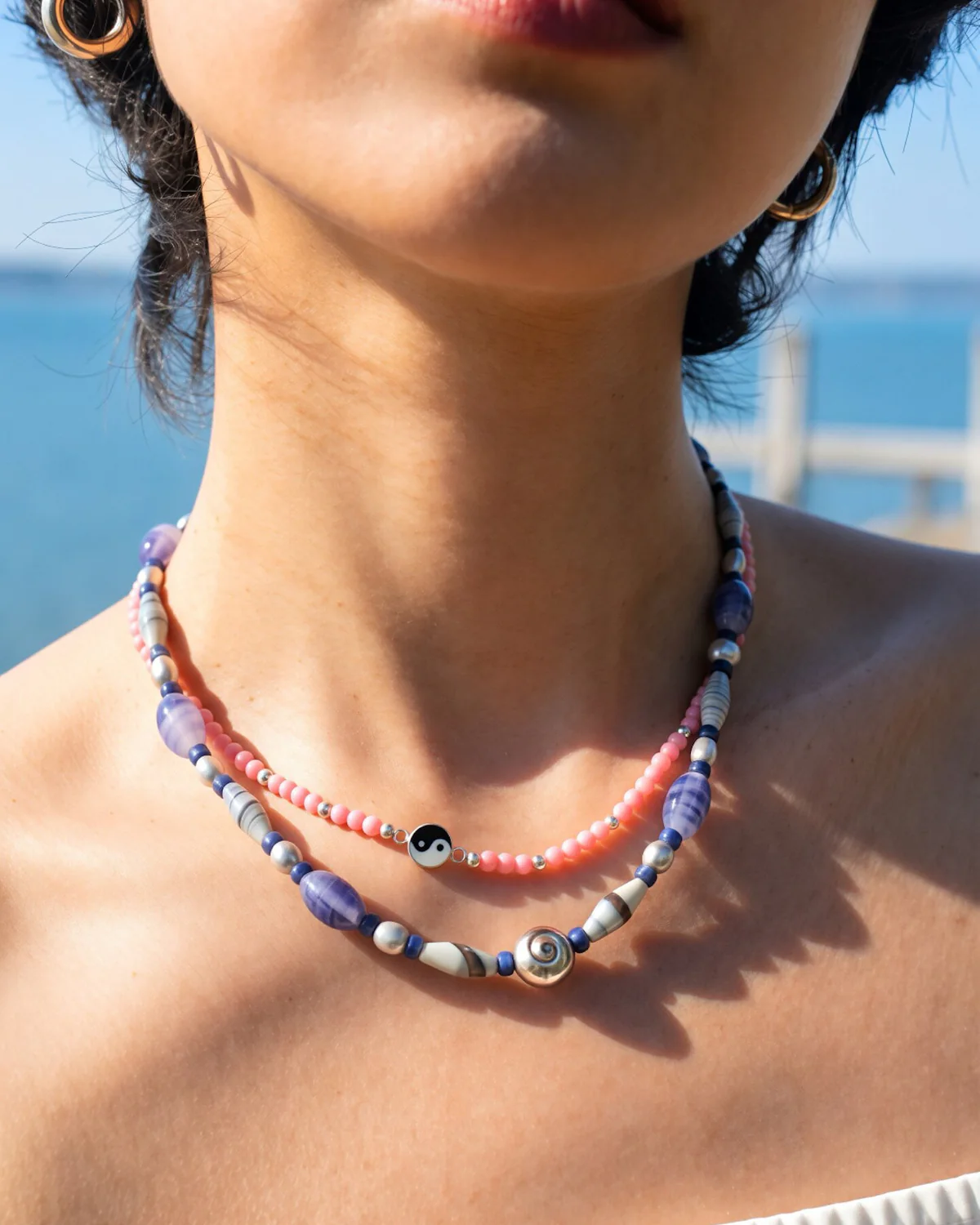Rhodonite and Blue Agate Necklace Layer Pink rhodonite yin yang necklace layered above a blue lace agate beaded necklace