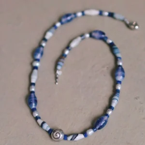 Blue agate beaded necklace laid flat with its clasp visible