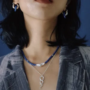 Blue lapis lazuli and pearl necklace worn from a side angle