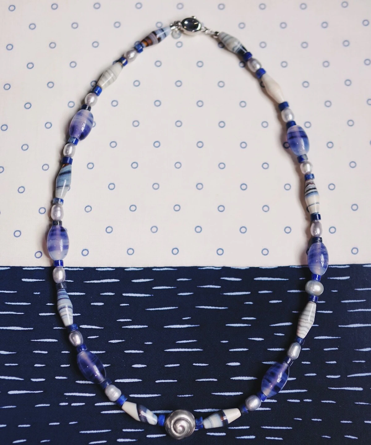 Blue lace agate necklace with grey pearls, blue glass and a silver spiral shell centre