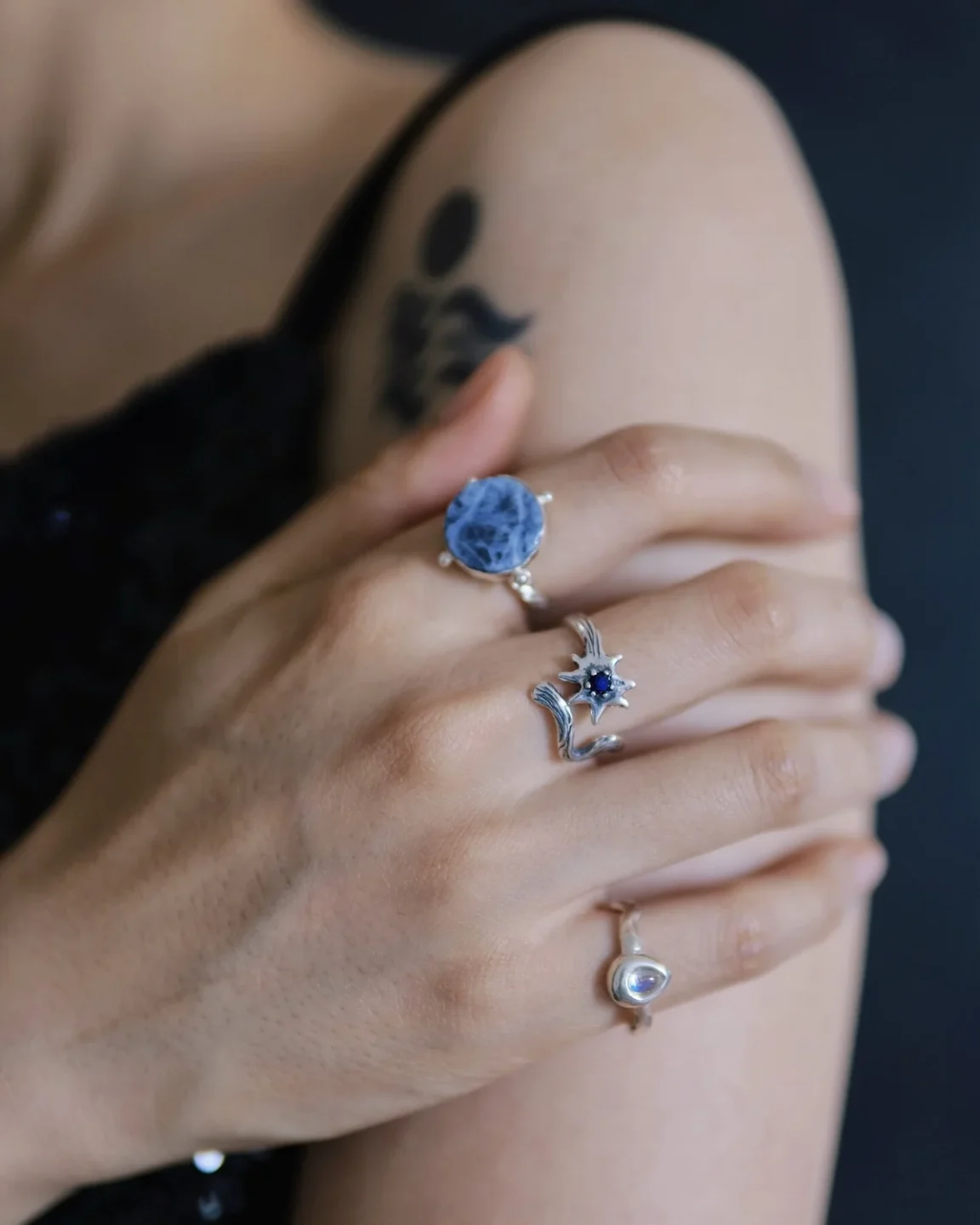 How to Wear Stacking Rings: Balance, Texture, and Space 1 Blue stone and celestial silver rings arranged across one hand