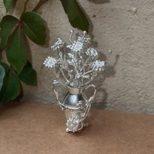 Daisy flowers arranged in a miniature 990 silver vase