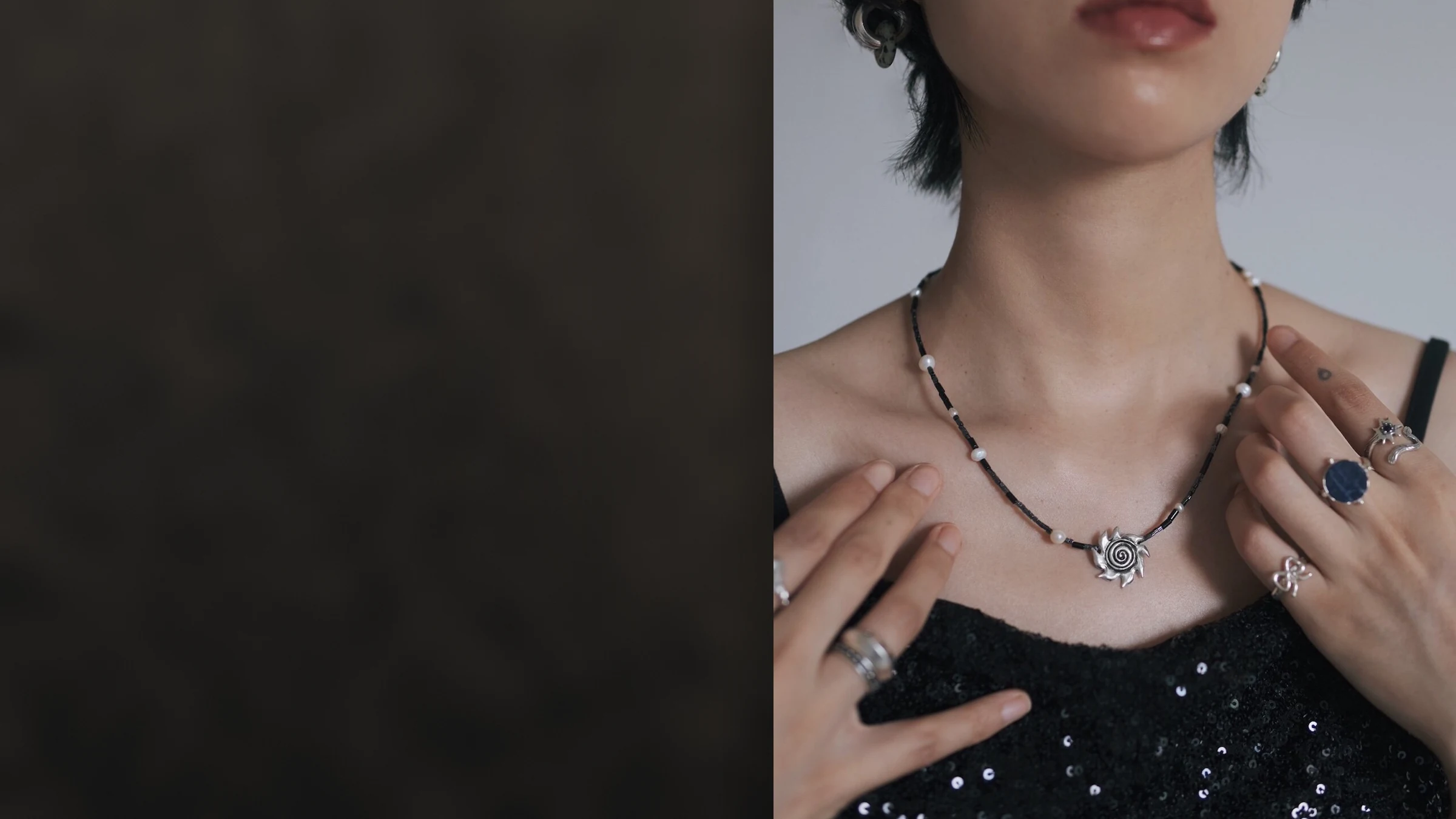 Model wearing the Light in the Dark spiral sun necklace and Night Wish lapis ring