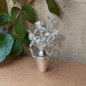 Iris flowers arranged in a miniature 990 silver vase