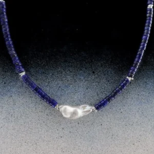 Close view of the baroque pearl centrepiece on a blue lapis lazuli necklace
