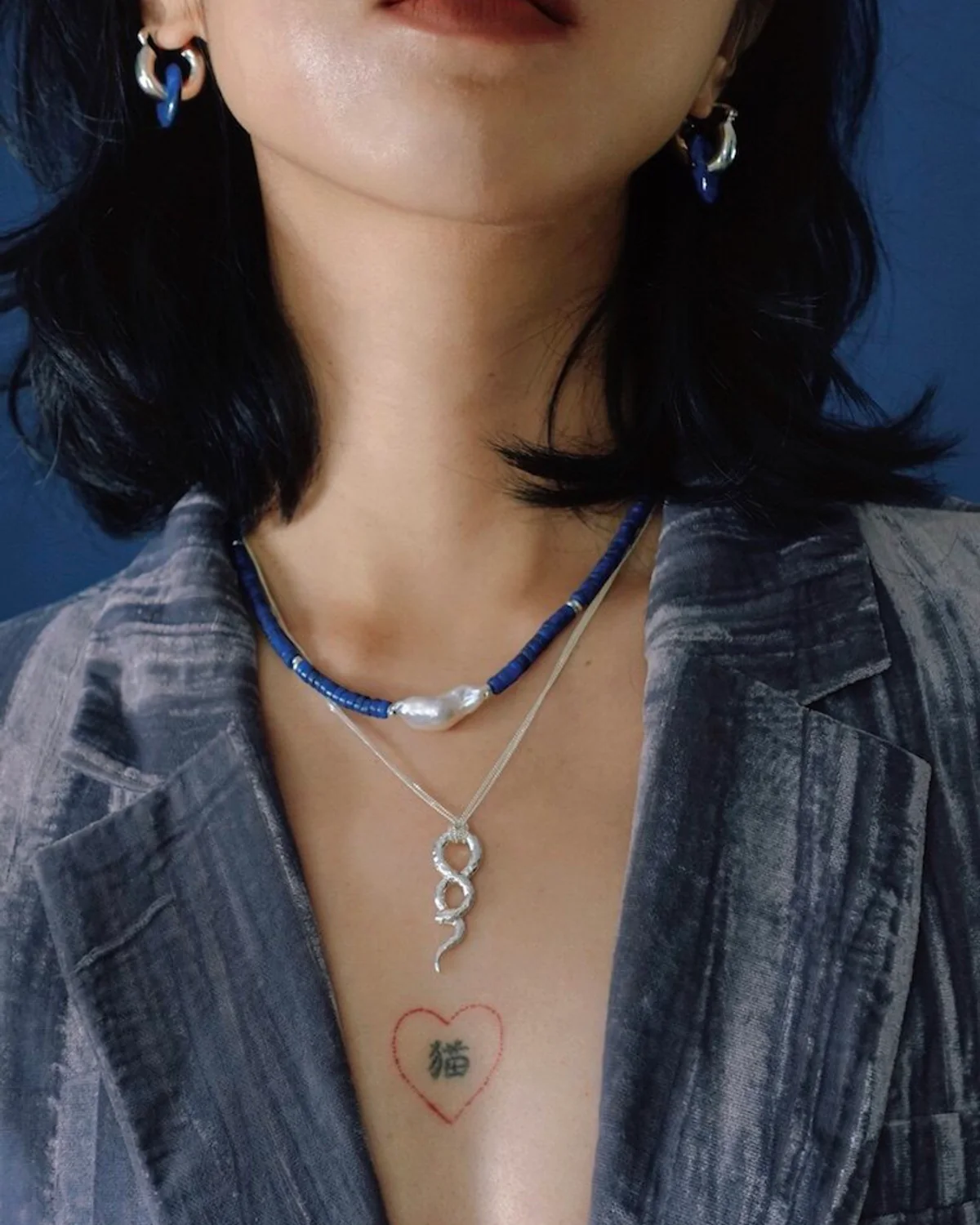 Pearl and Silver Snake Necklace Layer Lapis lazuli and baroque pearl strand layered above a sterling silver snake pendant