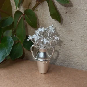 Lily flowers arranged in a miniature 990 silver vase