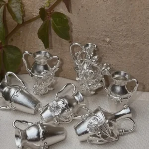 Collection of miniature 990 silver vase pendants with sculpted botanical details