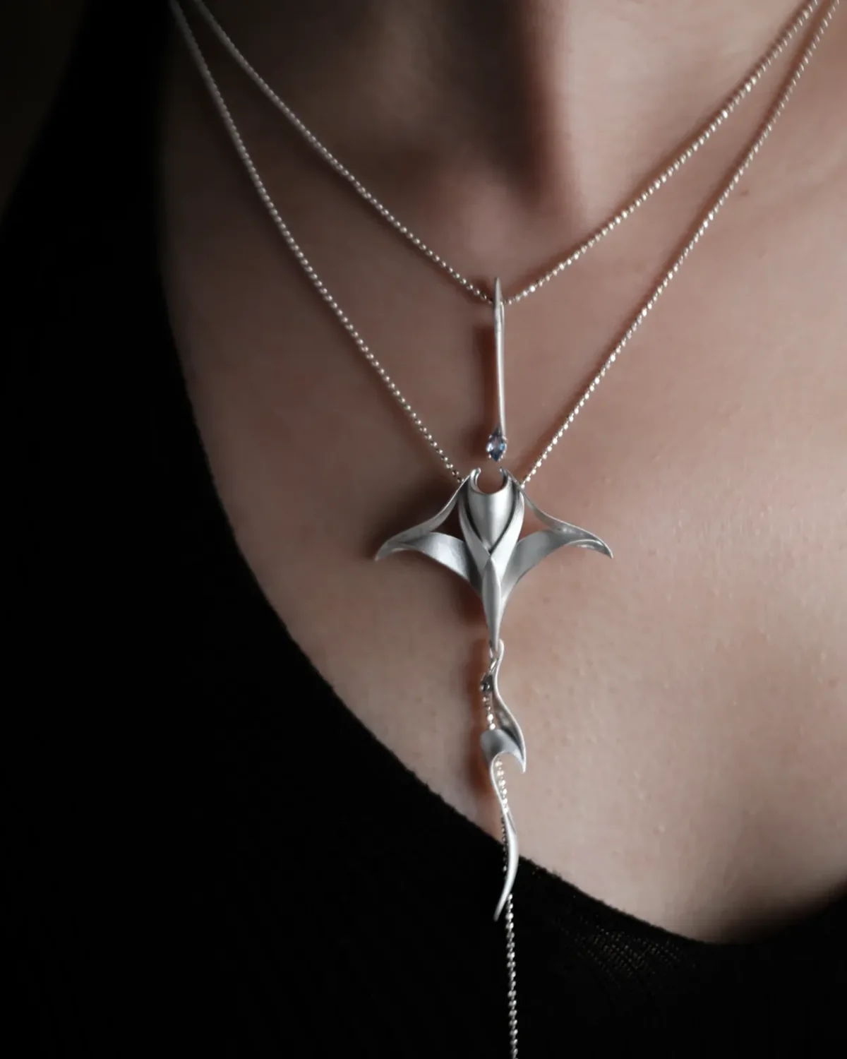 Pre-Layered Manta Ray Necklace Worn Layered sterling silver Manta Ray Necklace worn with a black V-neck top