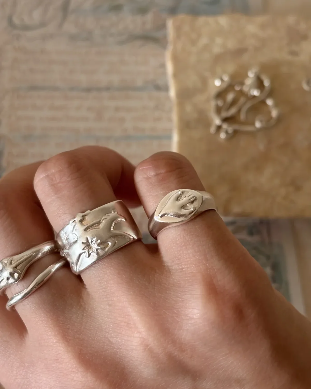 Wide relief silver rings balanced with two narrow organic bands