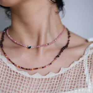 Rhodonite yin yang necklace layered with a longer dark bead strand