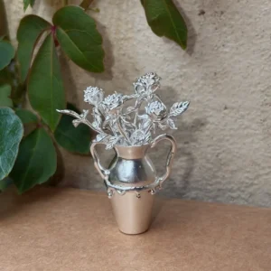 Rose flowers arranged in a miniature 990 silver vase