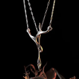 Sculptural sterling silver arrow necklace with matte bow curves on black