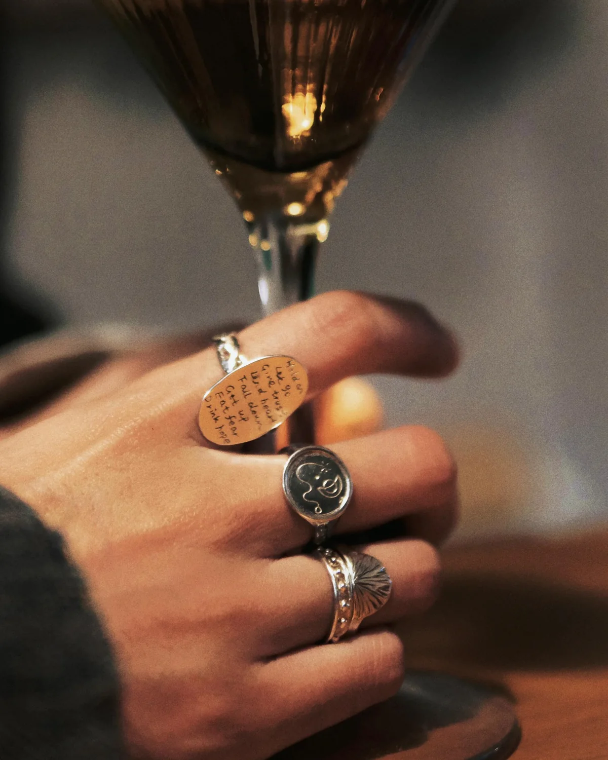 Several signet and carved rings connected by engraved and relief textures