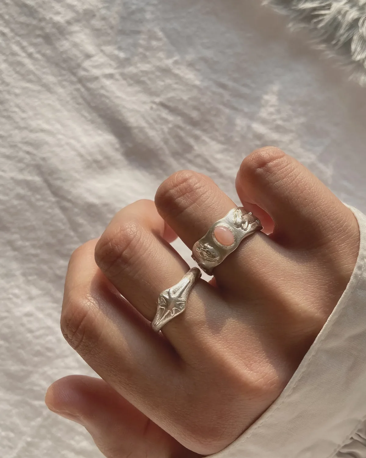 Hand curled while wearing two silver rings to test comfort through movement