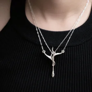 Sterling silver archery necklace worn at the centre of a black neckline