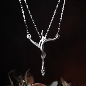 Sterling silver bow and arrow necklace suspended against a dark background