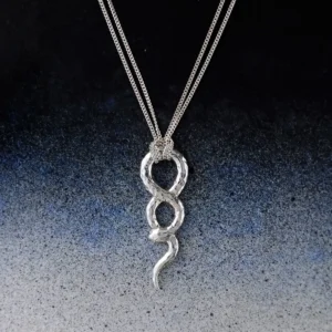 Sterling silver snake necklace with an infinity-shaped pendant and clear cubic zirconia accent on a blue-to-white background