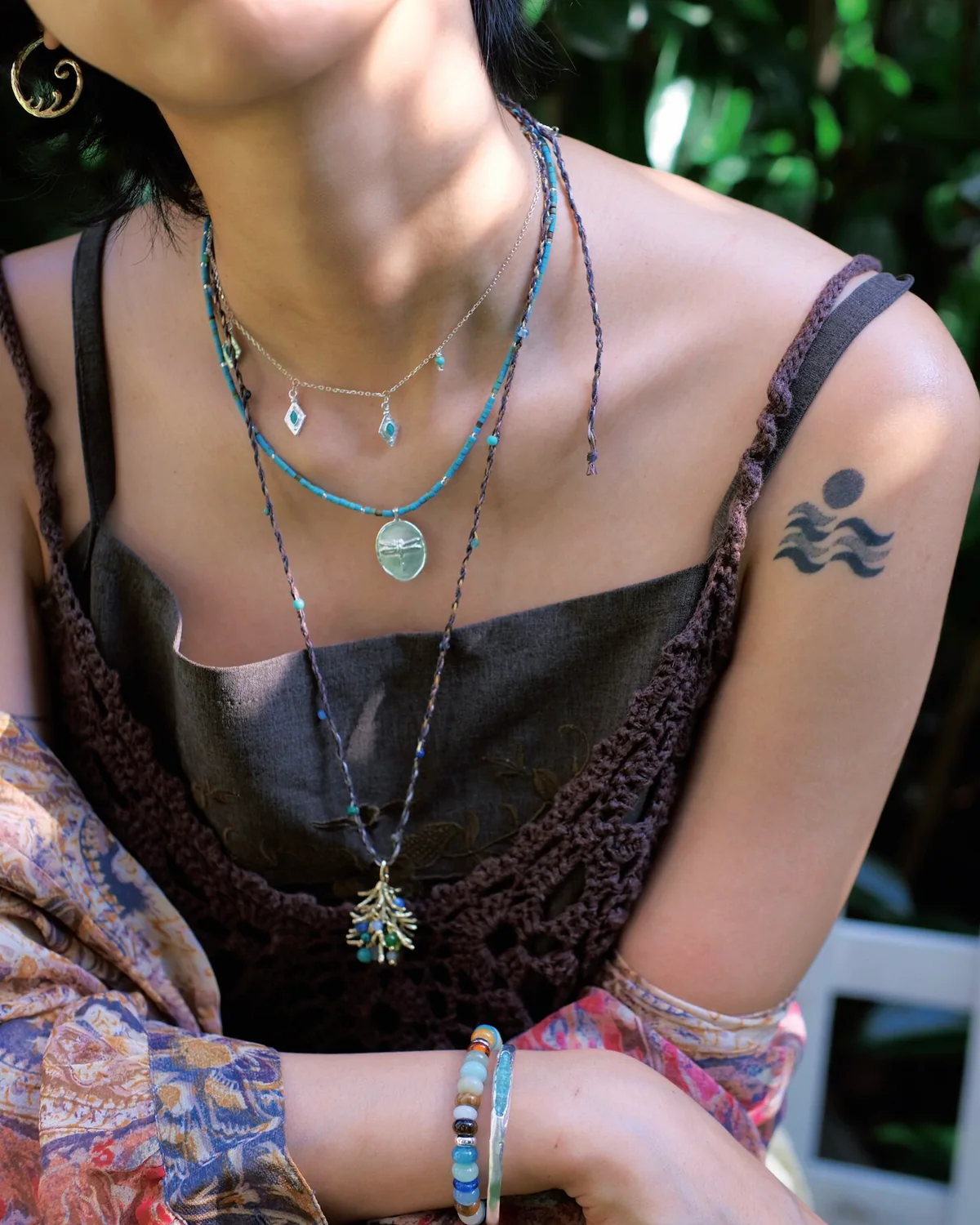 Three-Necklace Turquoise Stack Three necklace stack with turquoise charms, a green pendant and a long cord necklace