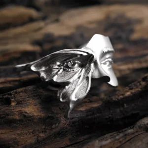 Front view of the Gaze moth ring in sterling silver, with an eye-like mark on its wing and a sculpted face behind it